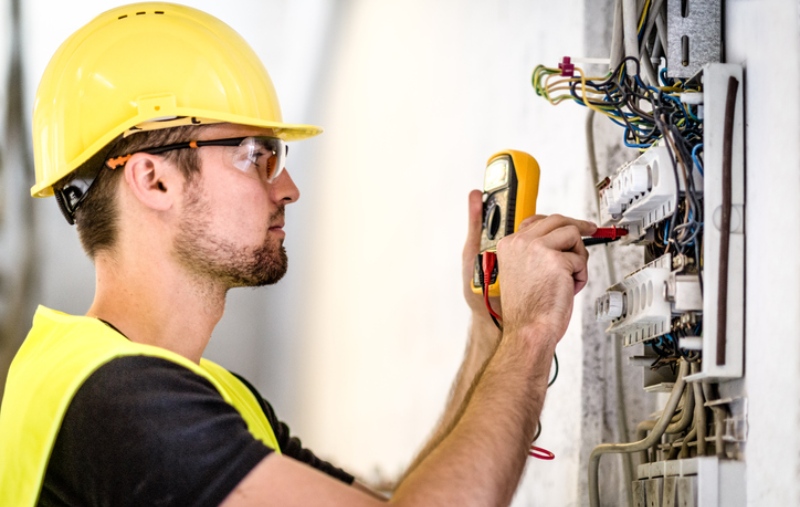 Mężczyzna w kasku przeprowadza pomiary